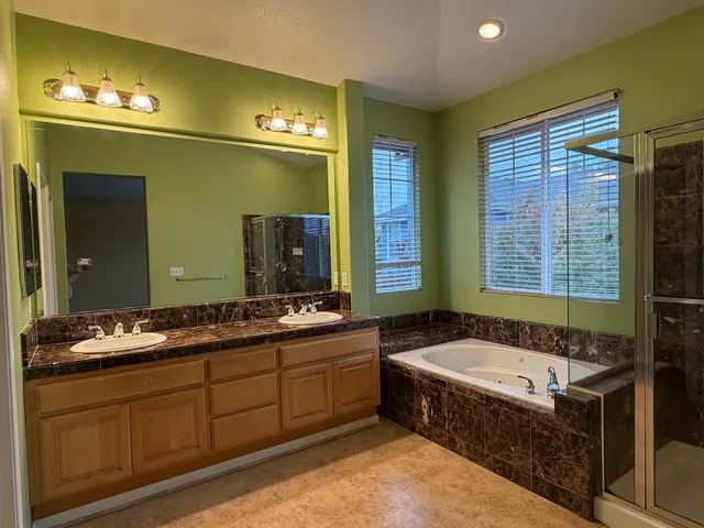 a spacious bathroom with sink shower and bathtub
