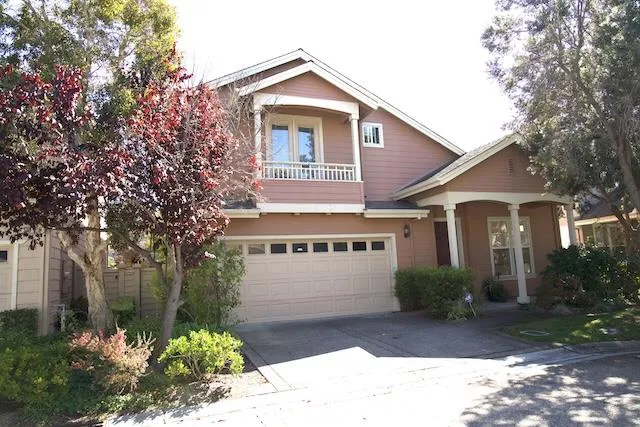 a view of a house with a yard and potted plants