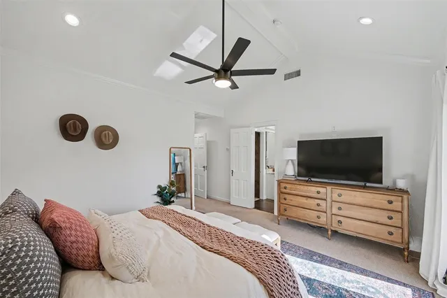 a bathroom with a sink a toilet and a large mirror
