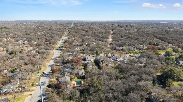 an aerial view of house with yard and mountain view in back