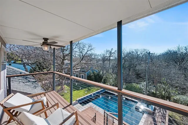 a view of a balcony with mountain view and wooden floor