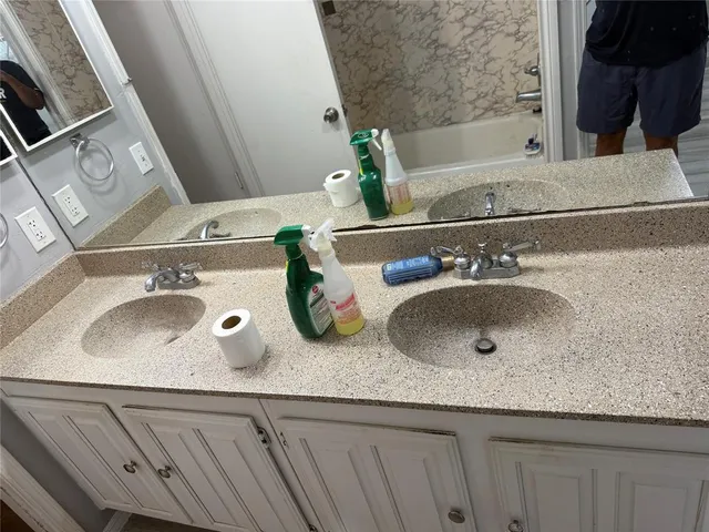 a bathroom with a sink and a mirror