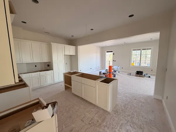 a kitchen with stainless steel appliances a stove a sink and a refrigerator