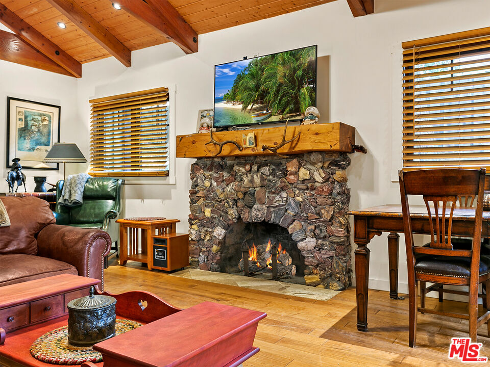 25643 Timpangos Drive Monte Nido, CA 91302 - Photo 14 of 24 a living room with furniture a fireplace and next to a window
