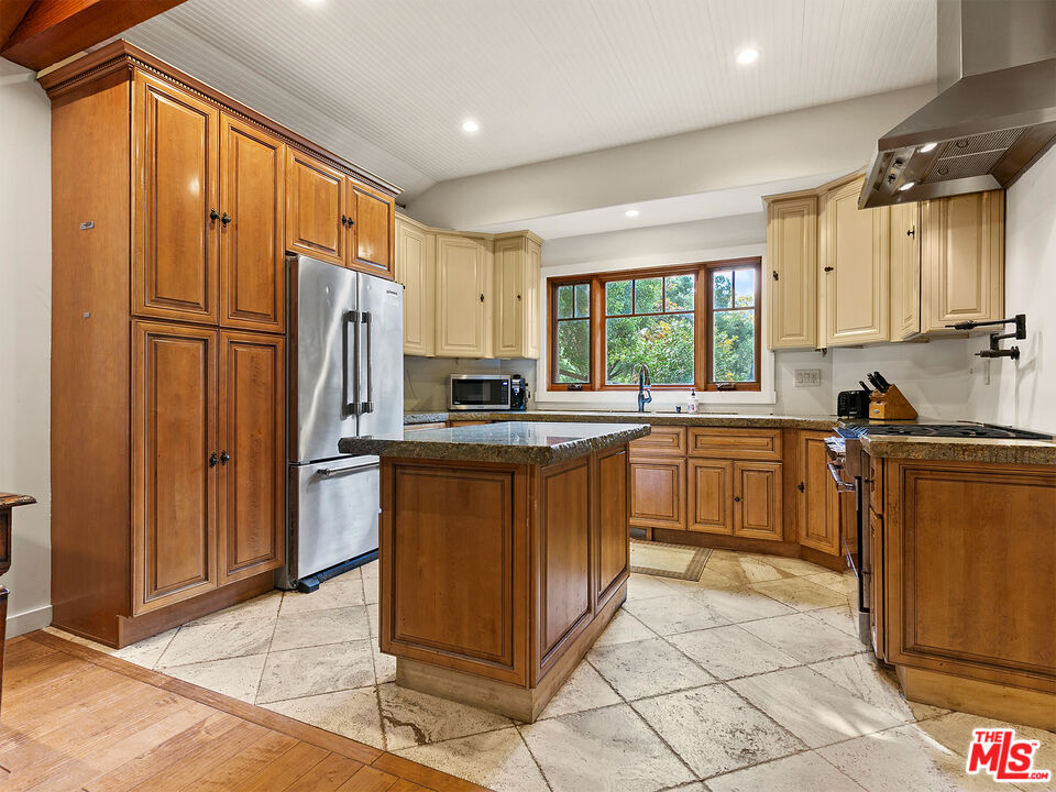 25643 Timpangos Drive Monte Nido, CA 91302 - Photo 16 of 24 a kitchen with granite countertop a refrigerator stove top oven and sink