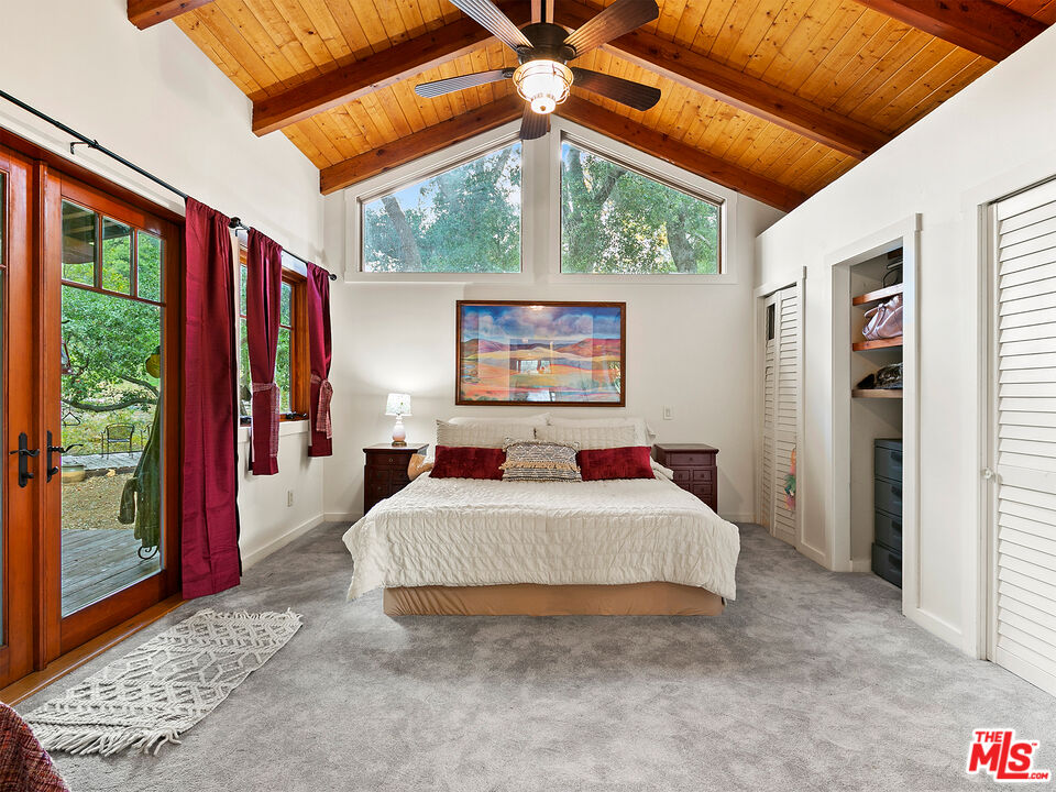 25643 Timpangos Drive Monte Nido, CA 91302 - Photo 18 of 24 a bedroom with a large bed and a window