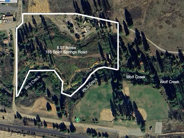 a view of a swimming pool with a lawn chairs under an umbrella