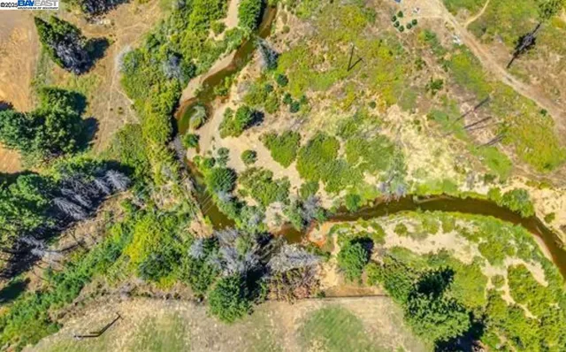 a view of a white house with large windows and a table