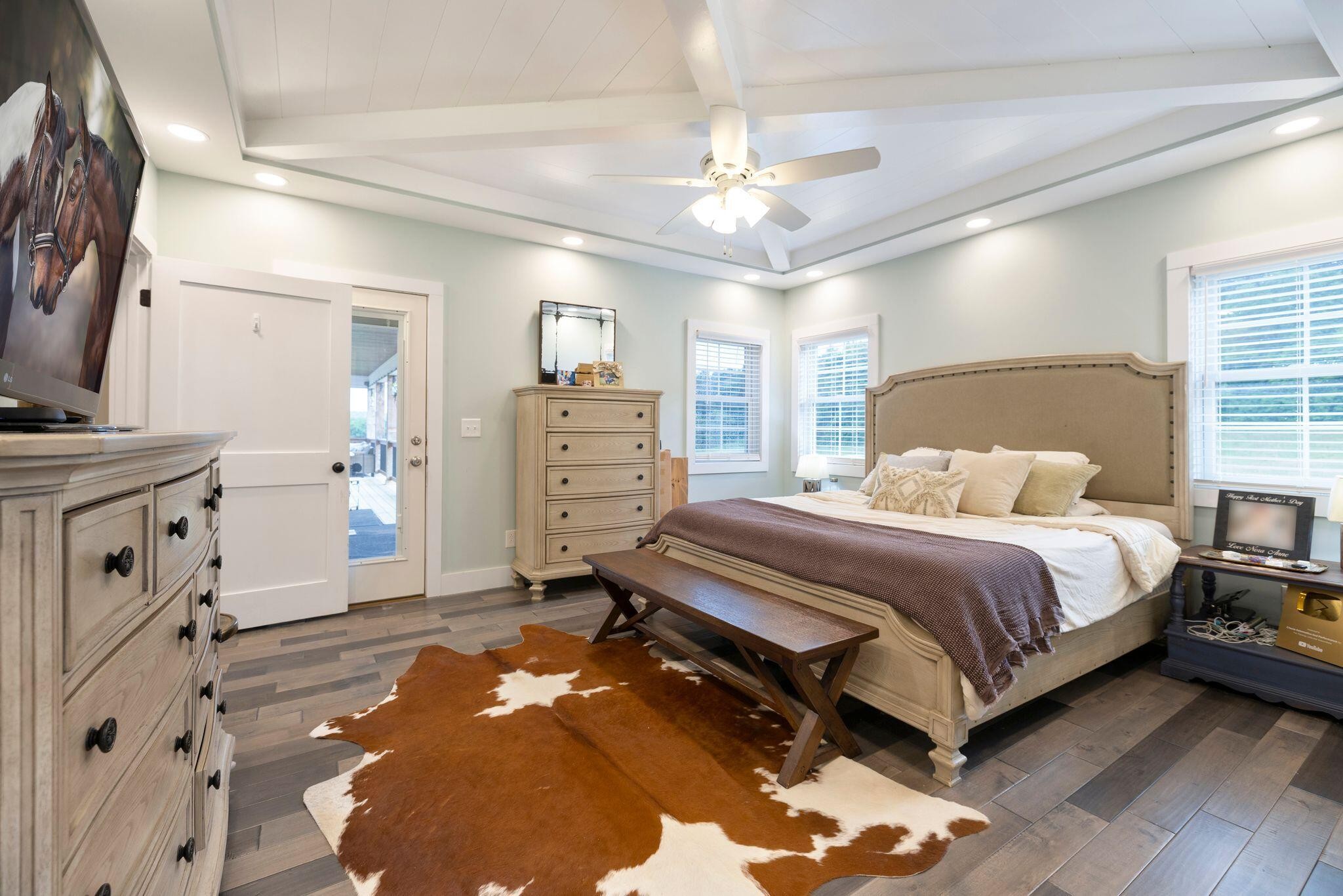 6866 Daus Mountain Road Whitwell, TN 37397 - Photo 15 of 49 a spacious bedroom with a bed and a chandelier