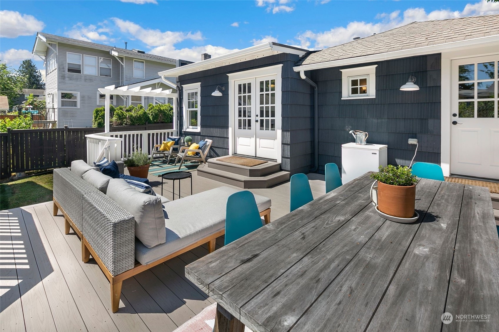 3244 Walnut Avenue Southwest Seattle, WA 98116 - Photo 27 of 40 a view of a patio with couches chairs potted plants and wooden floor