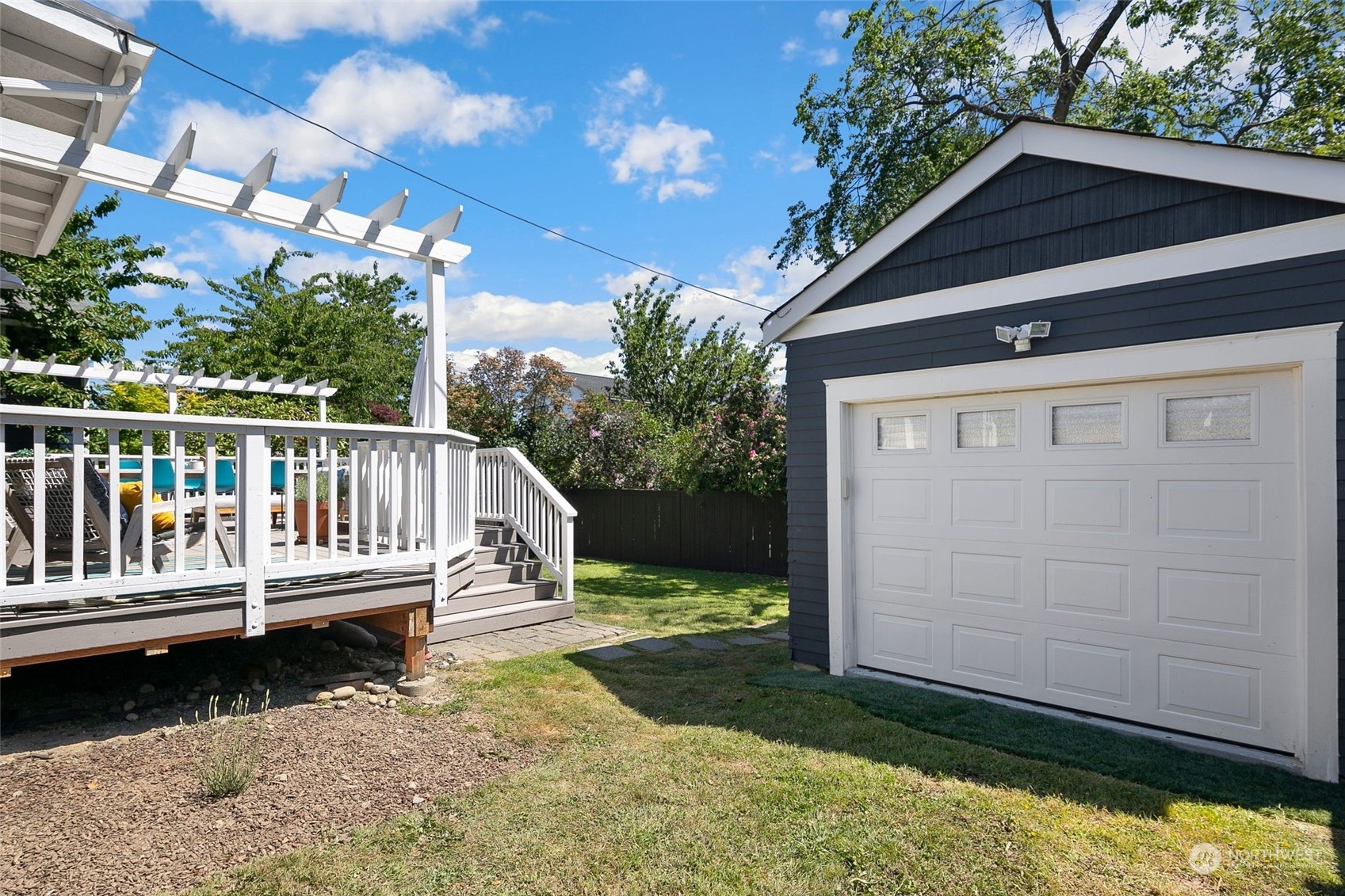 3244 Walnut Avenue Southwest Seattle, WA 98116 - Photo 31 of 40 a view of a wooden deck with a yard