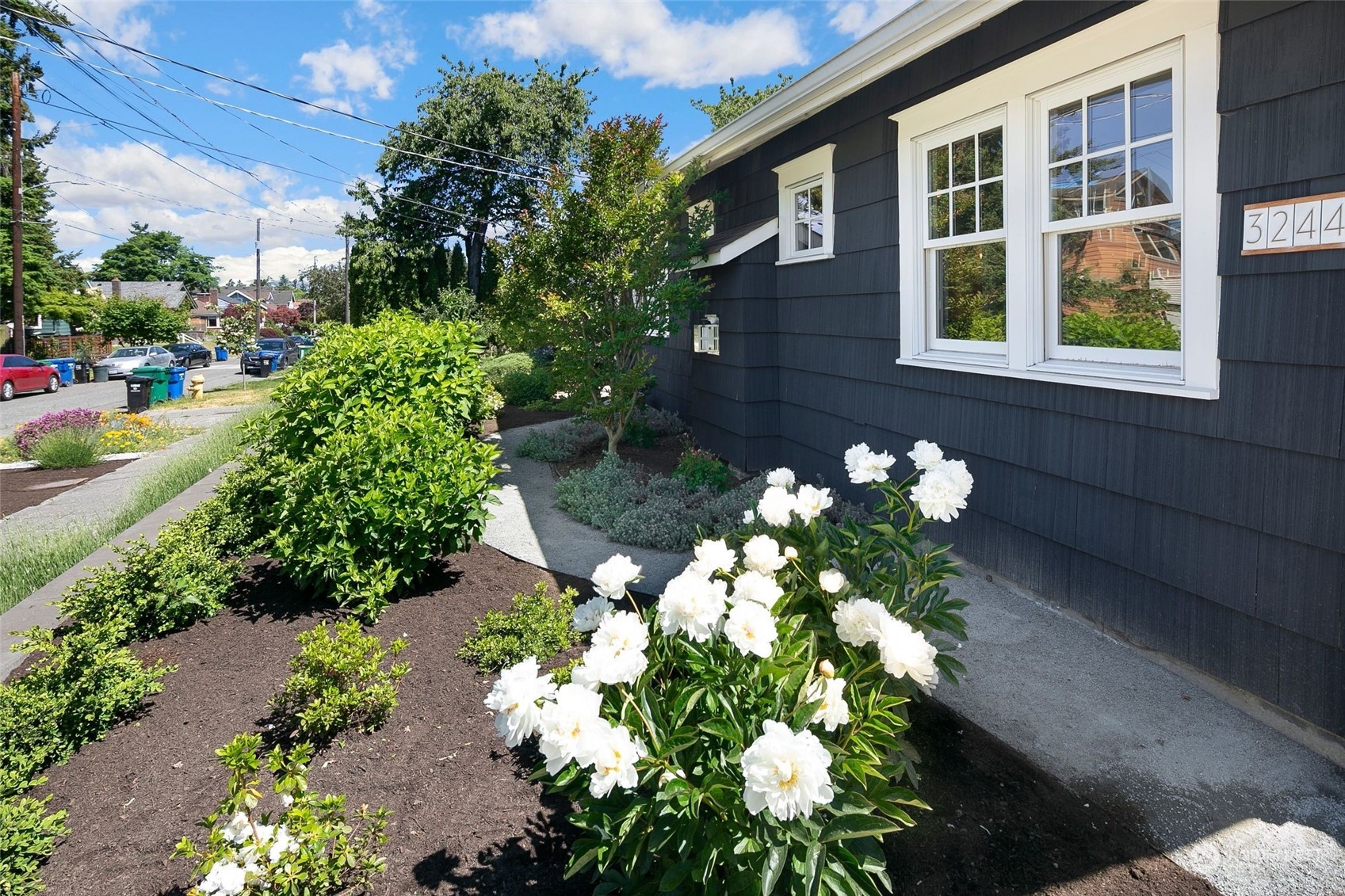3244 Walnut Avenue Southwest Seattle, WA 98116 - Photo 32 of 40 a front view of a house with a yard