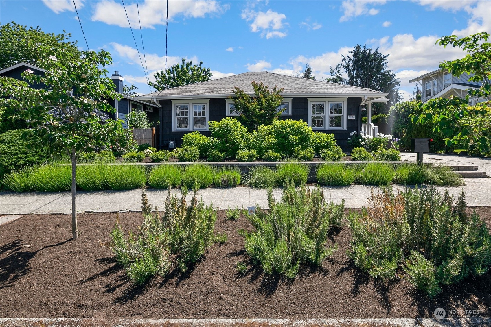3244 Walnut Avenue Southwest Seattle, WA 98116 - Photo 34 of 40 a front view of a house with a garden