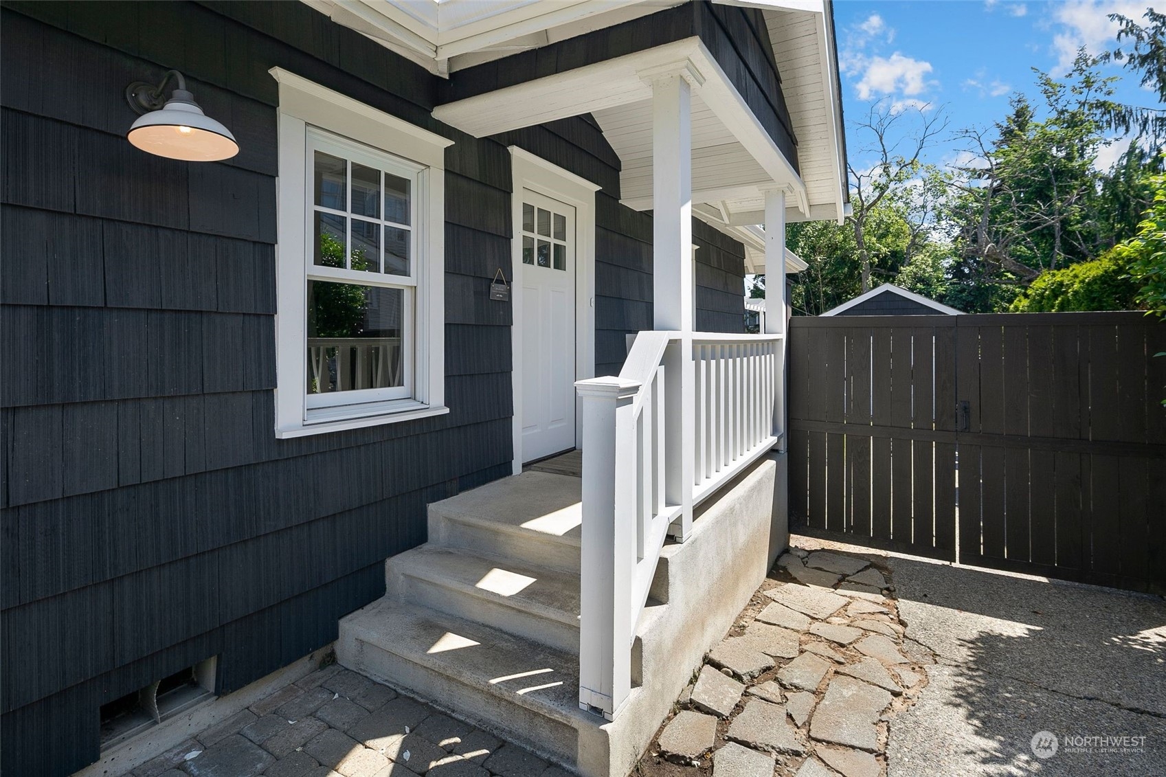 3244 Walnut Avenue Southwest Seattle, WA 98116 - Photo 35 of 40 a backyard of a house with wooden fence and large trees
