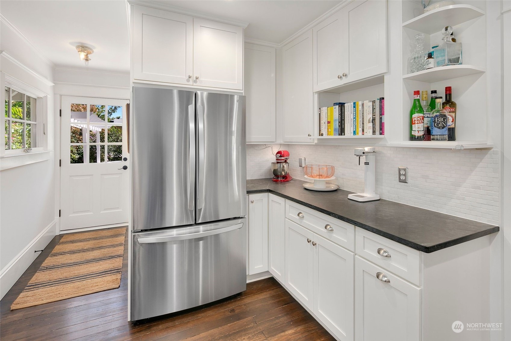 3244 Walnut Avenue Southwest Seattle, WA 98116 - Photo 4 of 40 a kitchen with wooden cabinets and stainless steel appliances