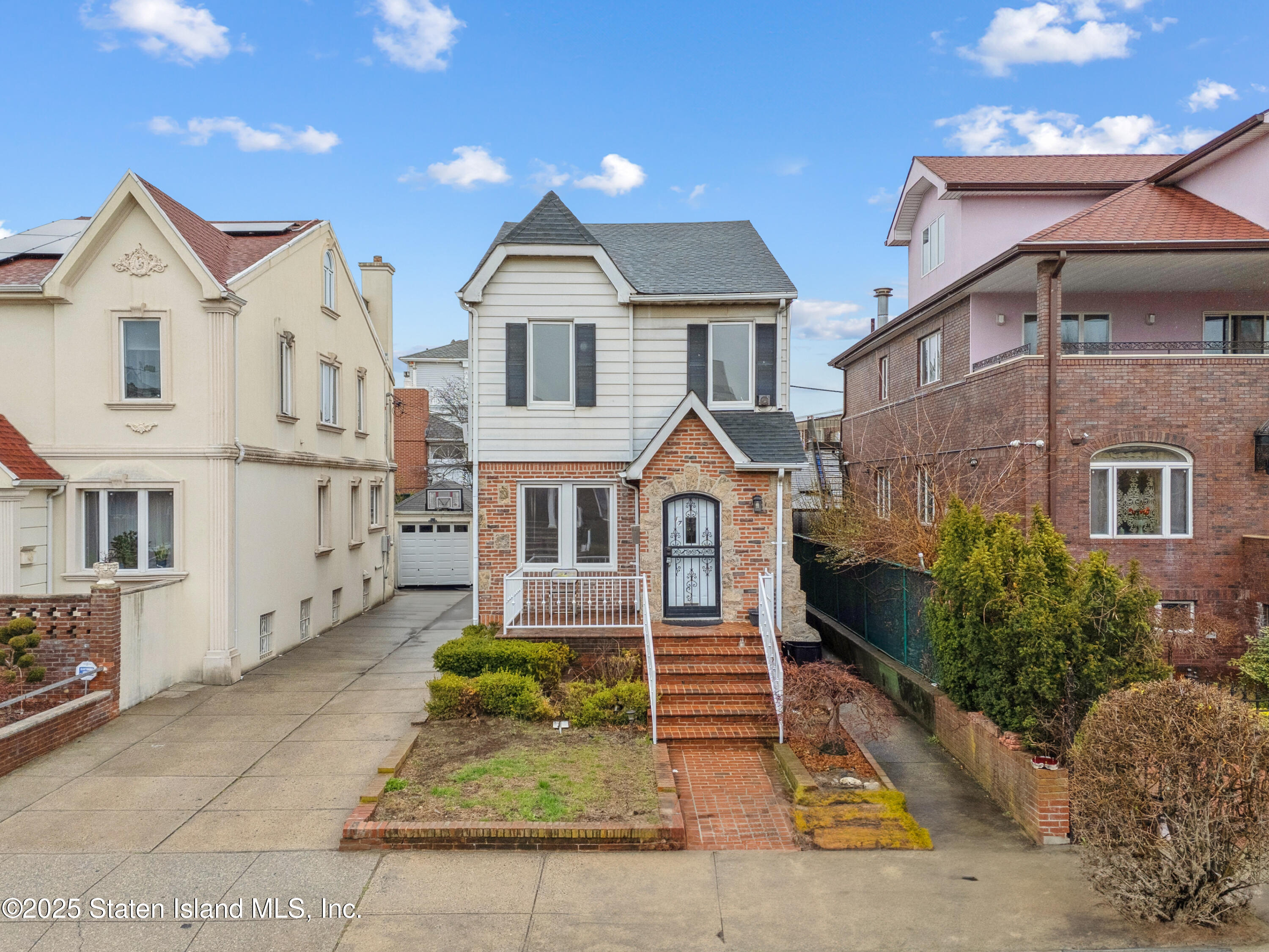 a front view of a house with garden