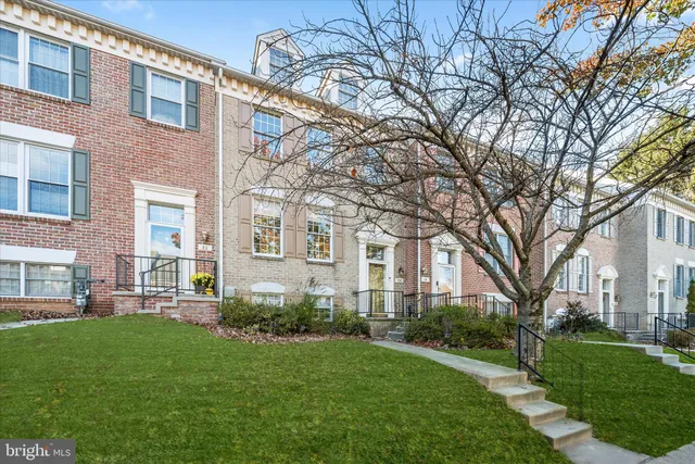 a front view of a building with a garden