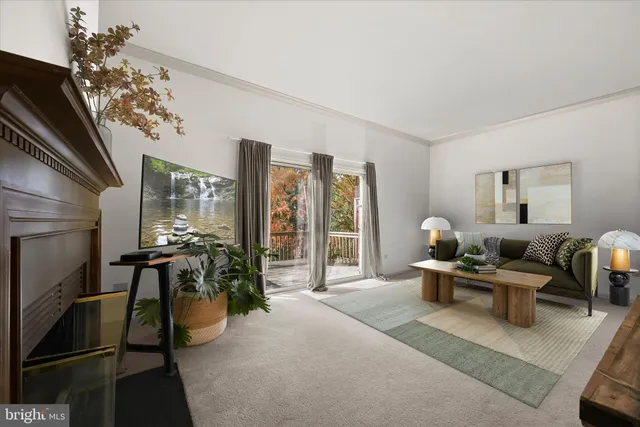 a view of a livingroom with a fireplace and a large window