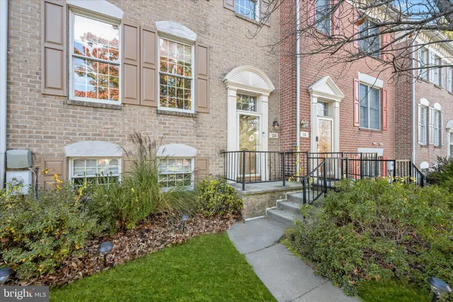 front view of a brick house with a yard