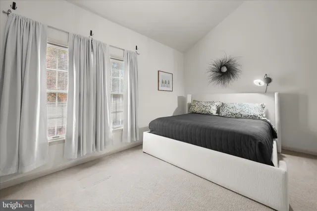 a bedroom with a bed and a couch