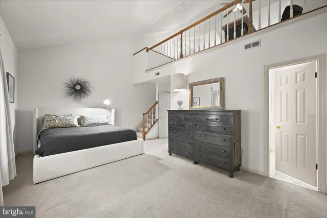 a spacious bathroom with a shower a sink and a mirror