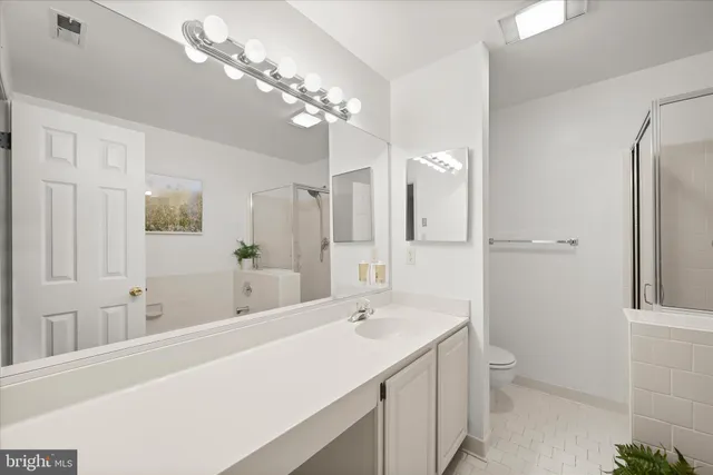 a living room with a couch and a ceiling fan