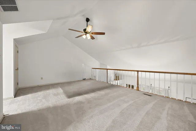 an empty room with windows and cabinet