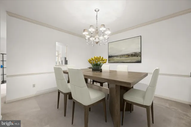 a view of a dining room with furniture and chandelier