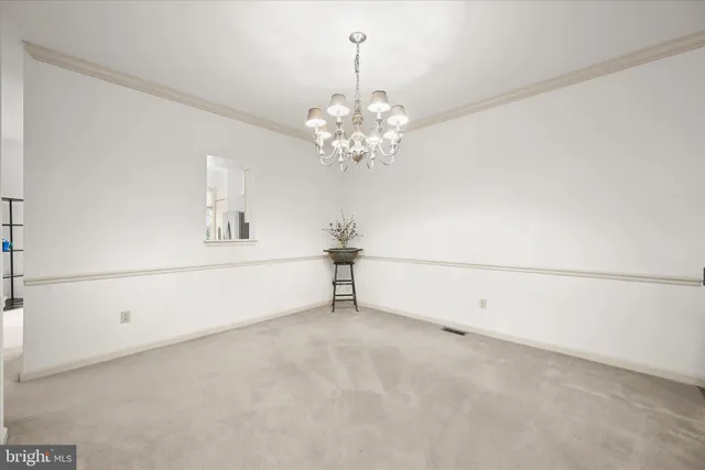 a view of a chandelier and chandelier fan in a room
