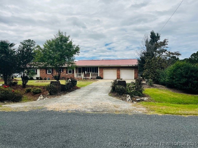 a view of a house with a yard patio and a garden