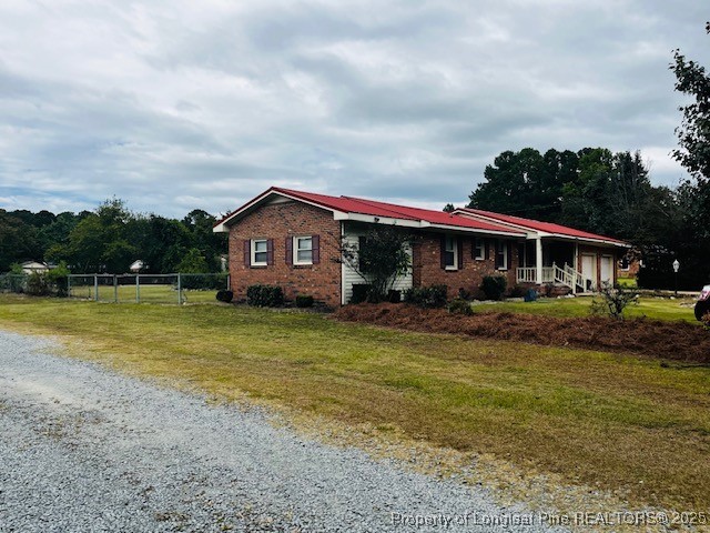 4141 Locks Creek Church Road Fayetteville, NC 28312 - Photo 23 of 23 a front view of a house with a yard table and chairs