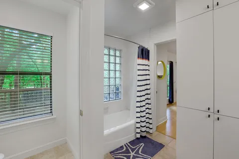 a view of a bedroom with a window and wooden floor