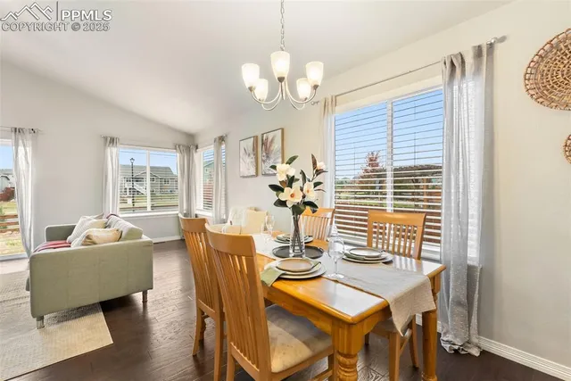 a bedroom with a bed a table and painting