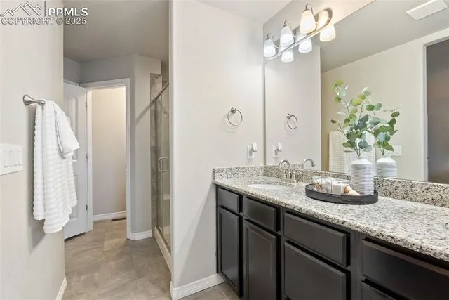 a bathroom with a granite countertop sink a toilet and a mirror