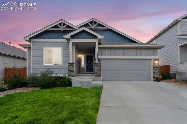 a kitchen with a dining table cabinets and stainless steel appliances