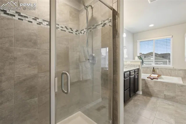 a living room with furniture a flat screen tv and kitchen view