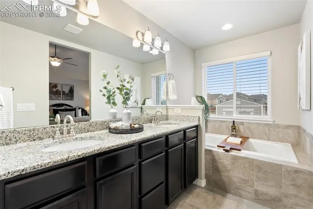 a kitchen with stainless steel appliances a sink dishwasher a refrigerator and a stove with wooden floor