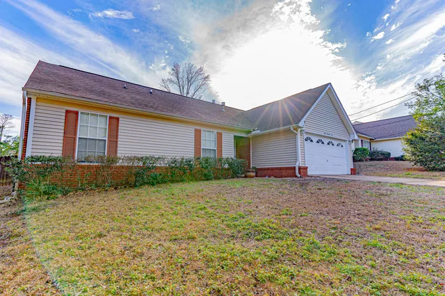 a view of a house with a yard and garage