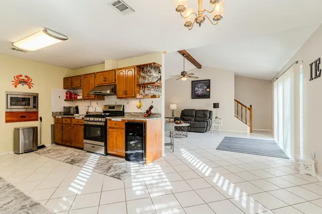 a kitchen with stainless steel appliances granite countertop a stove and cabinets