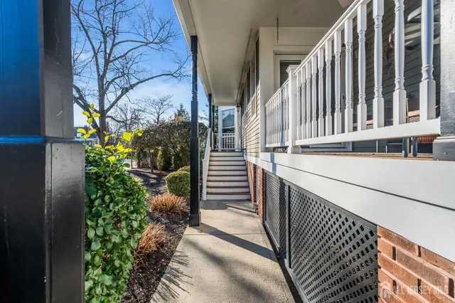 a view of balcony with wooden floor and fence