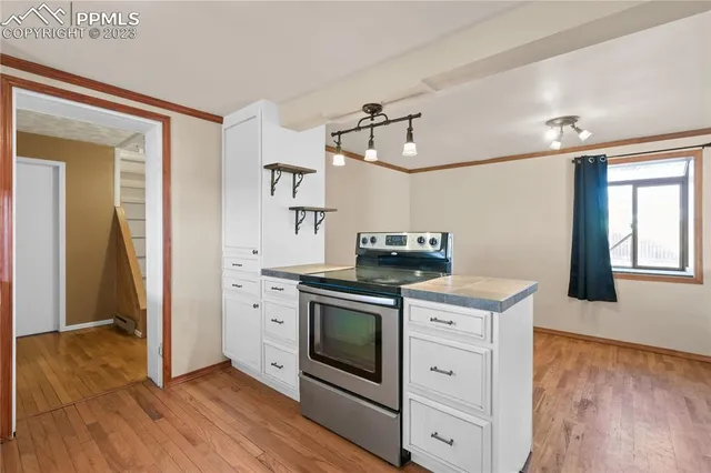 a kitchen with a stove oven and sink