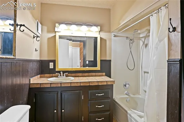 a bathroom with a sink vanity granite and a mirror