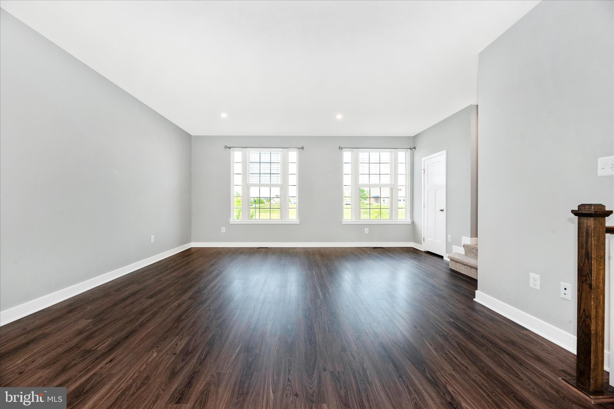 7091 Kokanee Way New Market, MD 21774 - Photo 8 of 69 an empty room with wooden floor and windows