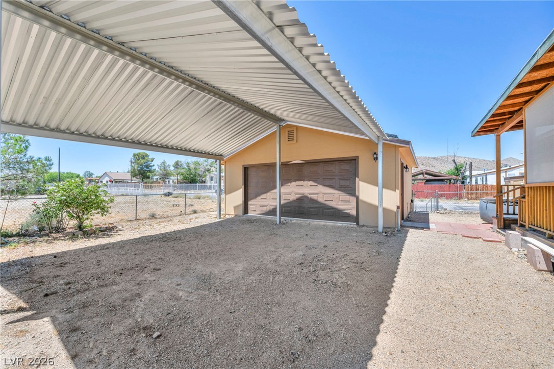 225 California Street Searchlight, NV 89046 - Photo 14 of 64 Secure parking solutions with a robust carport and double garage.