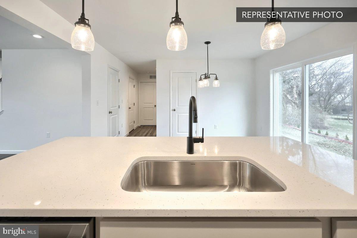 Pin Oak 5br Plan At Hills Spring Grove, PA 17362 - Photo 12 of 38 a kitchen with a sink a chandelier and chandelier