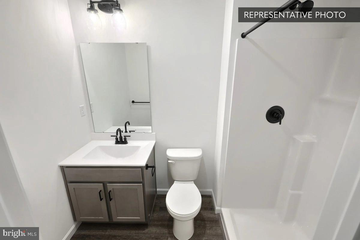 Pin Oak 5br Plan At Hills Spring Grove, PA 17362 - Photo 18 of 38 a bathroom with a toilet sink and mirror