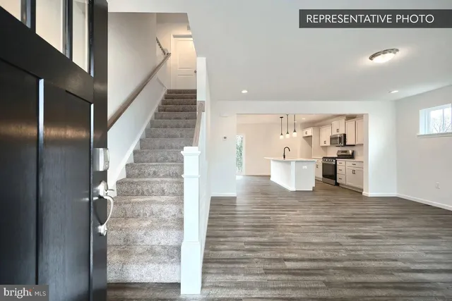 a view of kitchen with wooden floor and electronic appliances