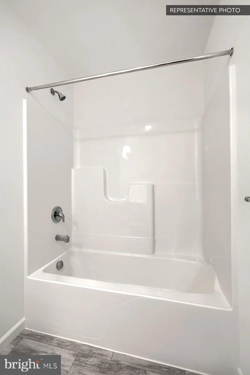 Pin Oak 5br Plan At Hills Spring Grove, PA 17362 - Photo 34 of 38 a bathroom with a shower and a bath tub