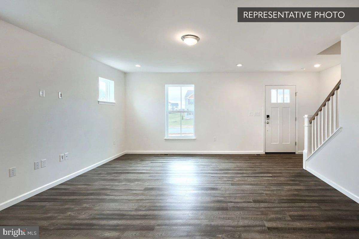 Pin Oak 5br Plan At Hills Spring Grove, PA 17362 - Photo 5 of 38 a view of an empty room with wooden floor and a window