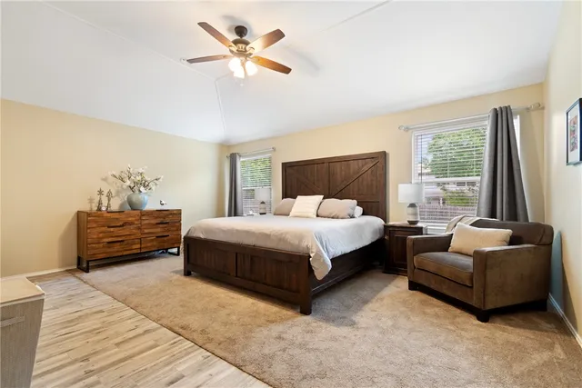 a bedroom with a bed a couch and a window